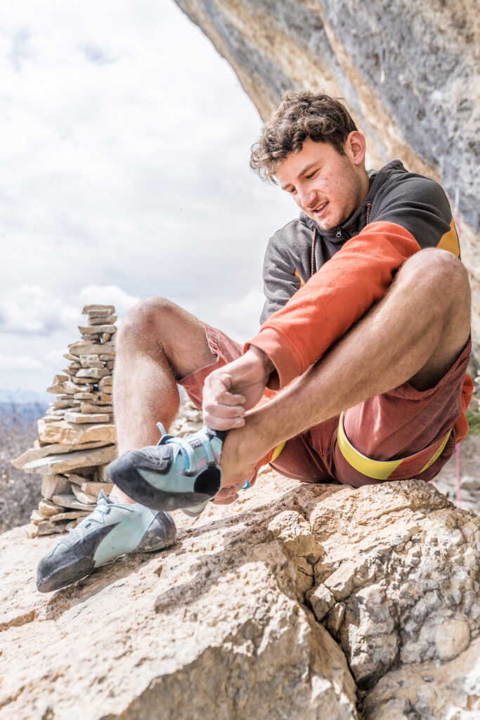 Rock climber Tanguy Merard puts on Tenaya Indalo climbing shoes before climbing Biographie.