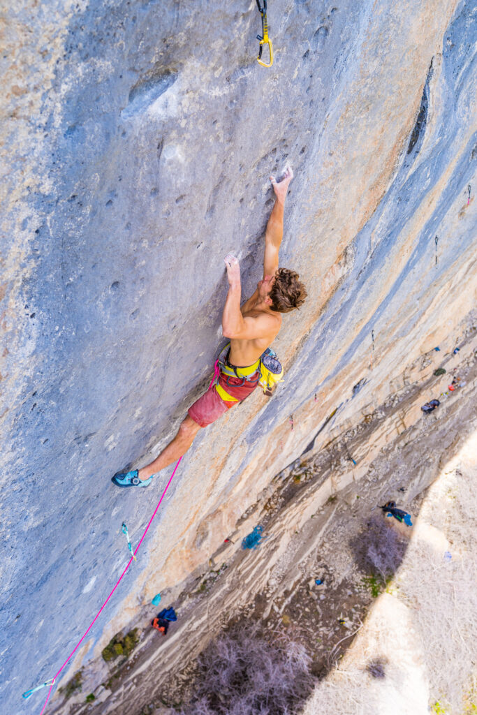 Rock climber on a sport route at Céüse, France.